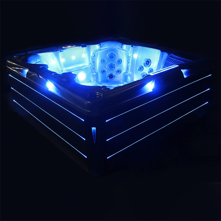 ReefSpa Ovaka hot tub glowing blue in the dark with cabinet LED strips